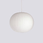 White silk bubble pendant light suspended in a styled room