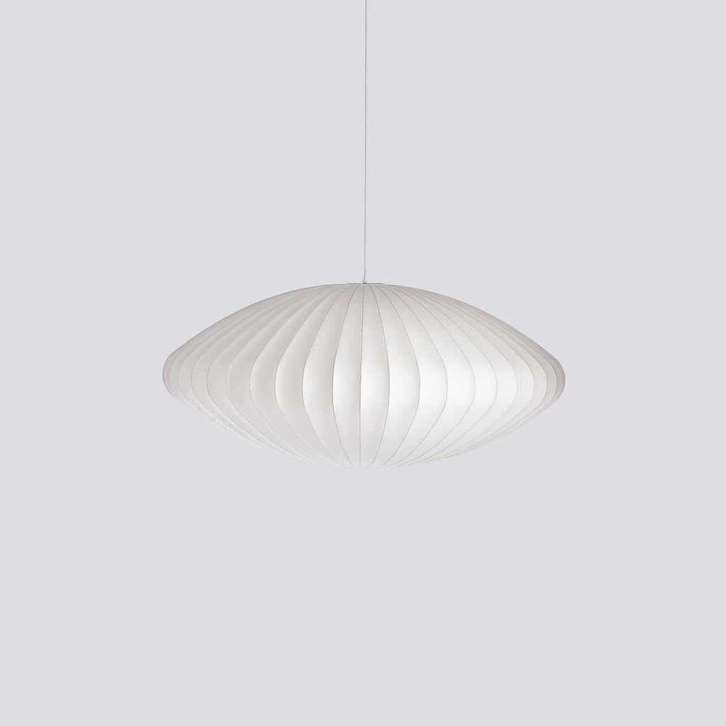 White mulberry silk bubble pendant light glowing above a dining table