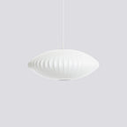 White bubble pendant light suspended low in a styled interior