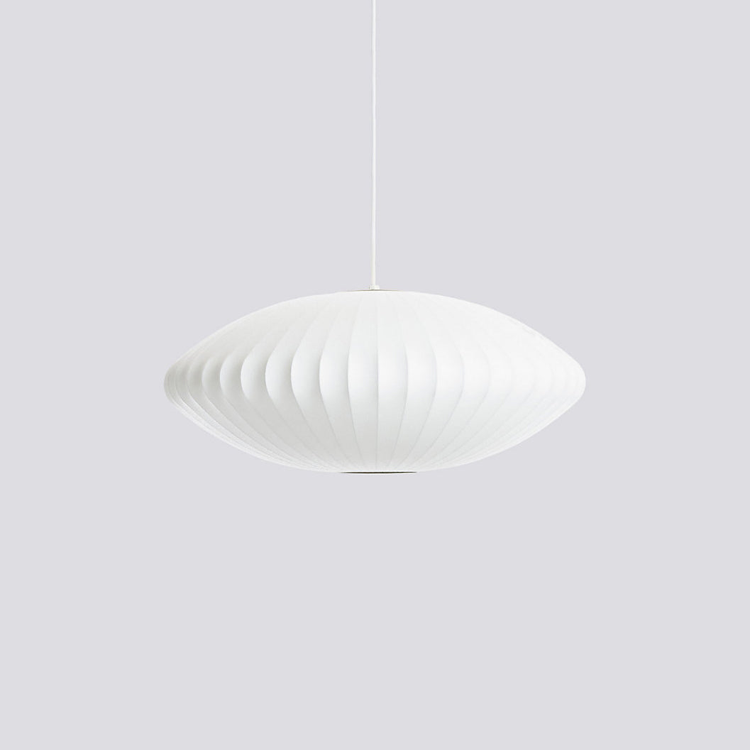 White bubble pendant light suspended low in a styled interior