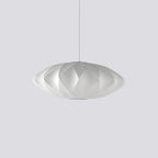 White silk bubble pendant light casting a gentle amber glow