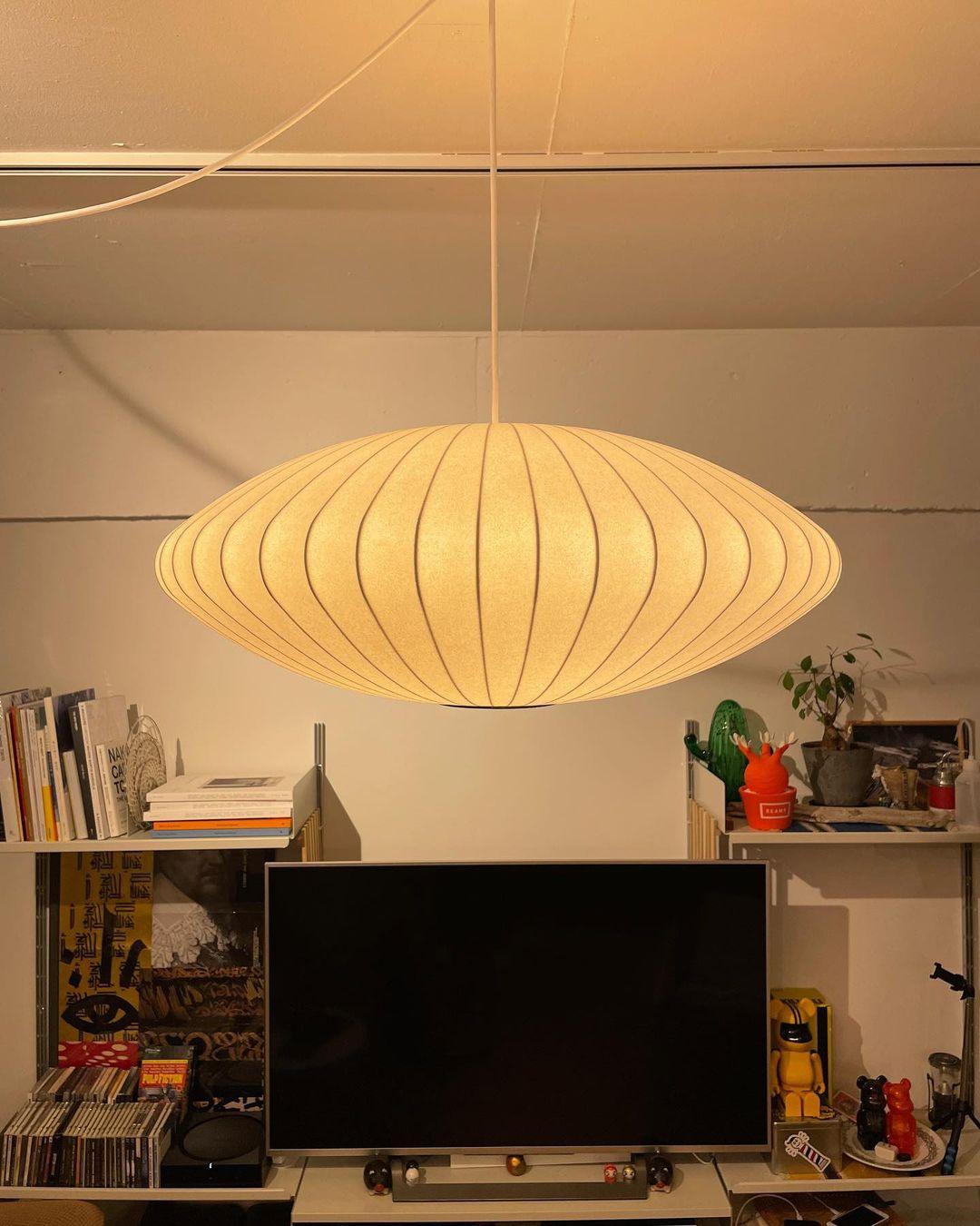 Nelson Bubble Swag Pendant Light hung over a dining table