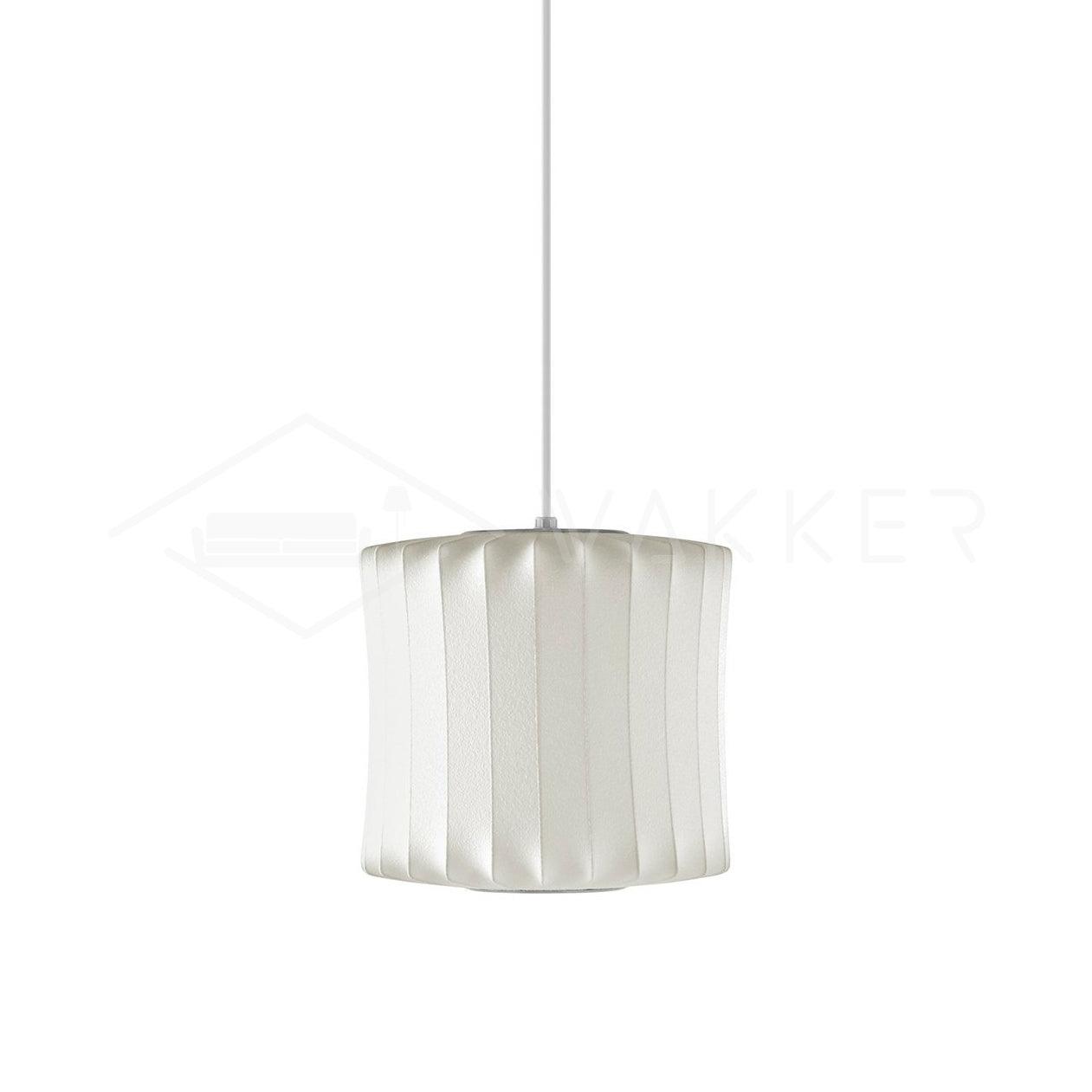 Lantern-shaped silk bubble pendant light glowing over a table