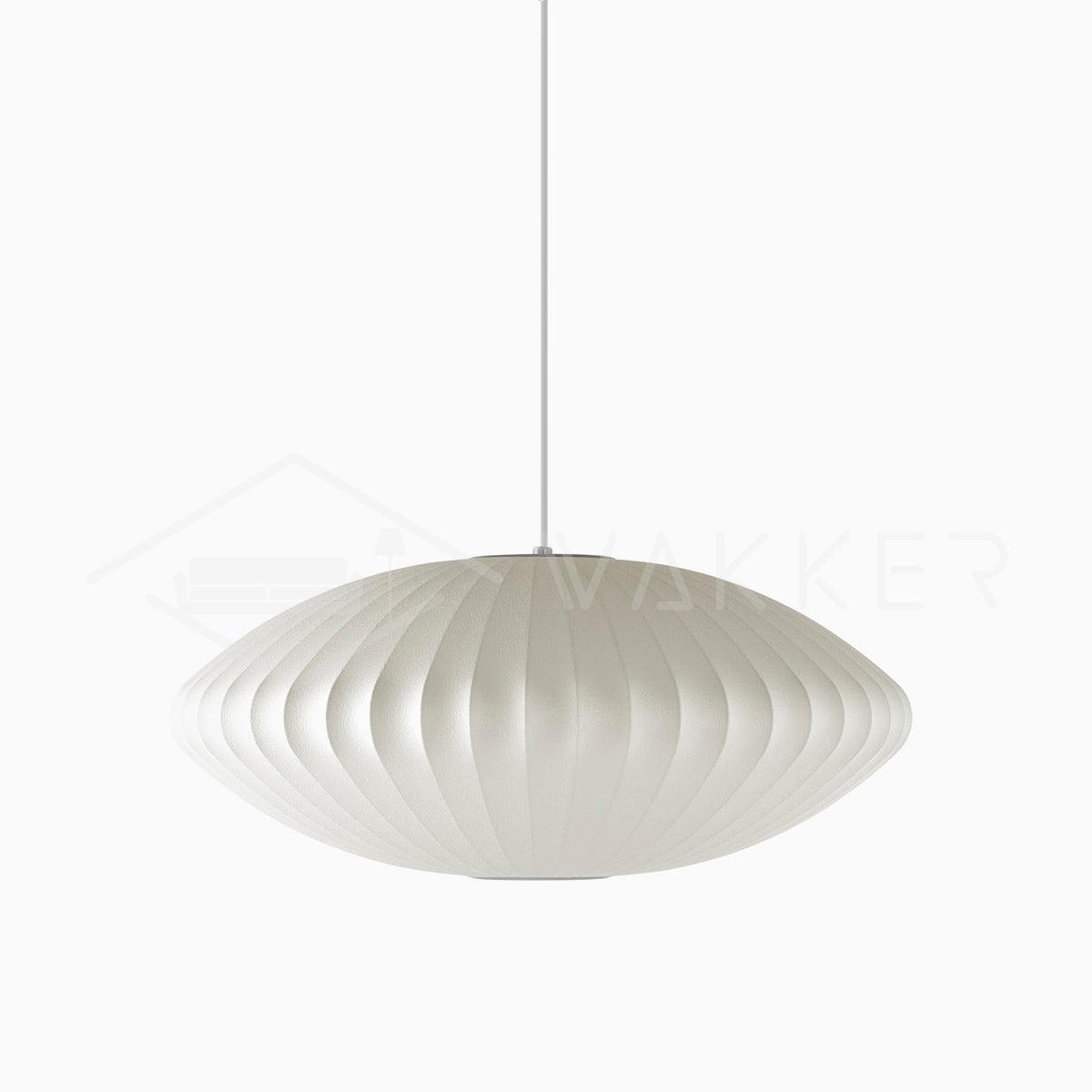 White saucer bubble pendant light glowing over a table setting