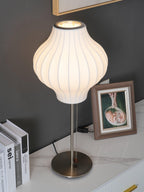 Side profile of the faux silk bubble table lamp and round chrome base
