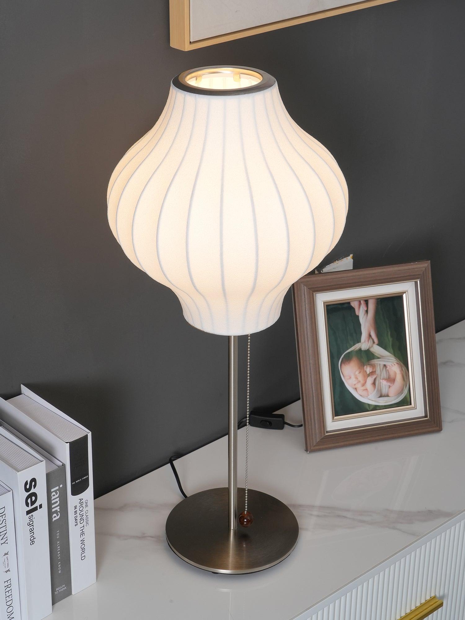 Side profile of the faux silk bubble table lamp and round chrome base