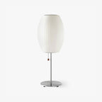 Chrome-stemmed faux silk bubble table lamp glowing in a cosy living room