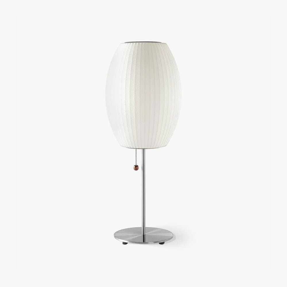 Chrome-stemmed faux silk bubble table lamp glowing in a cosy living room