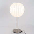 Side profile of the faux silk bubble table lamp and round chrome base