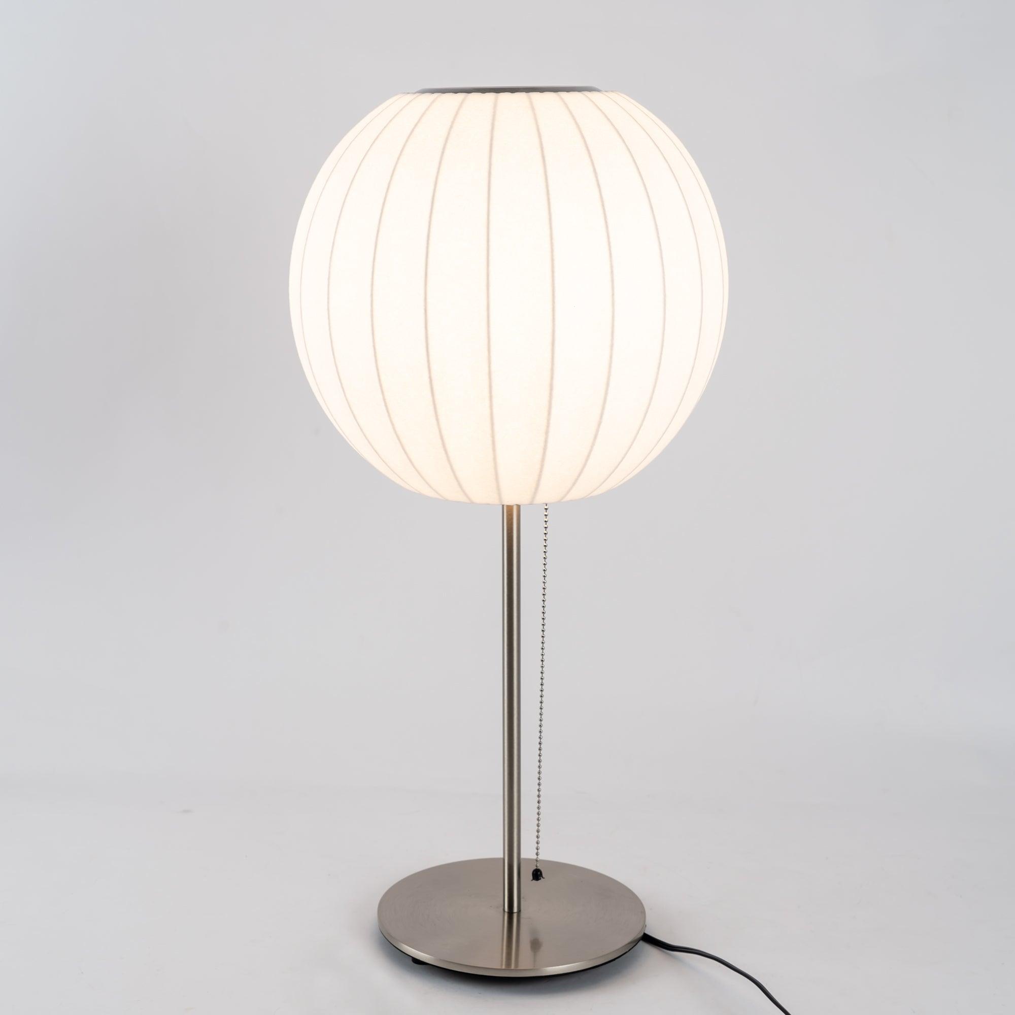 Side profile of the faux silk bubble table lamp and round chrome base