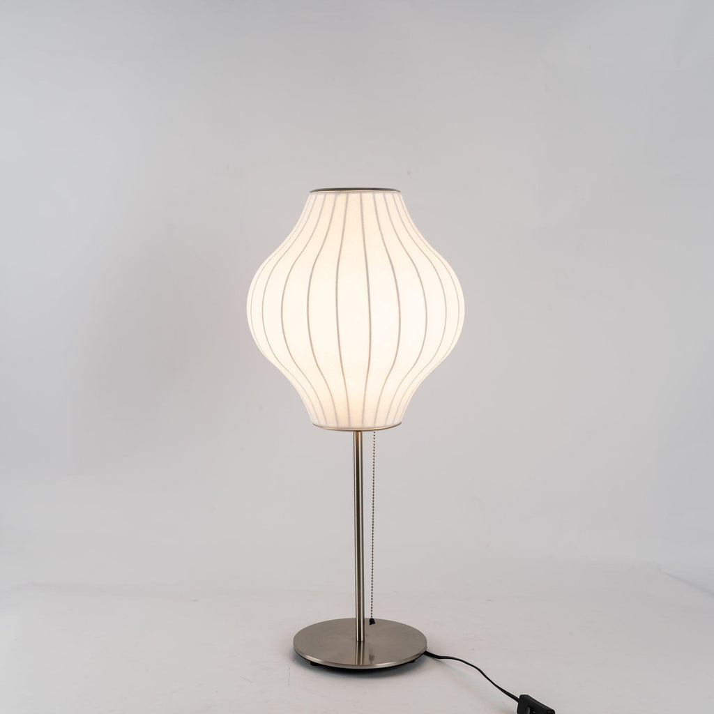 Faux silk bubble table lamp on a bedside table casting a soft diffused glow