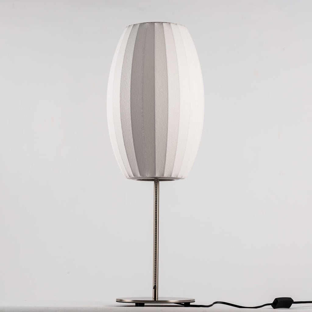 Chrome-stemmed faux silk bubble table lamp glowing in a cosy living room