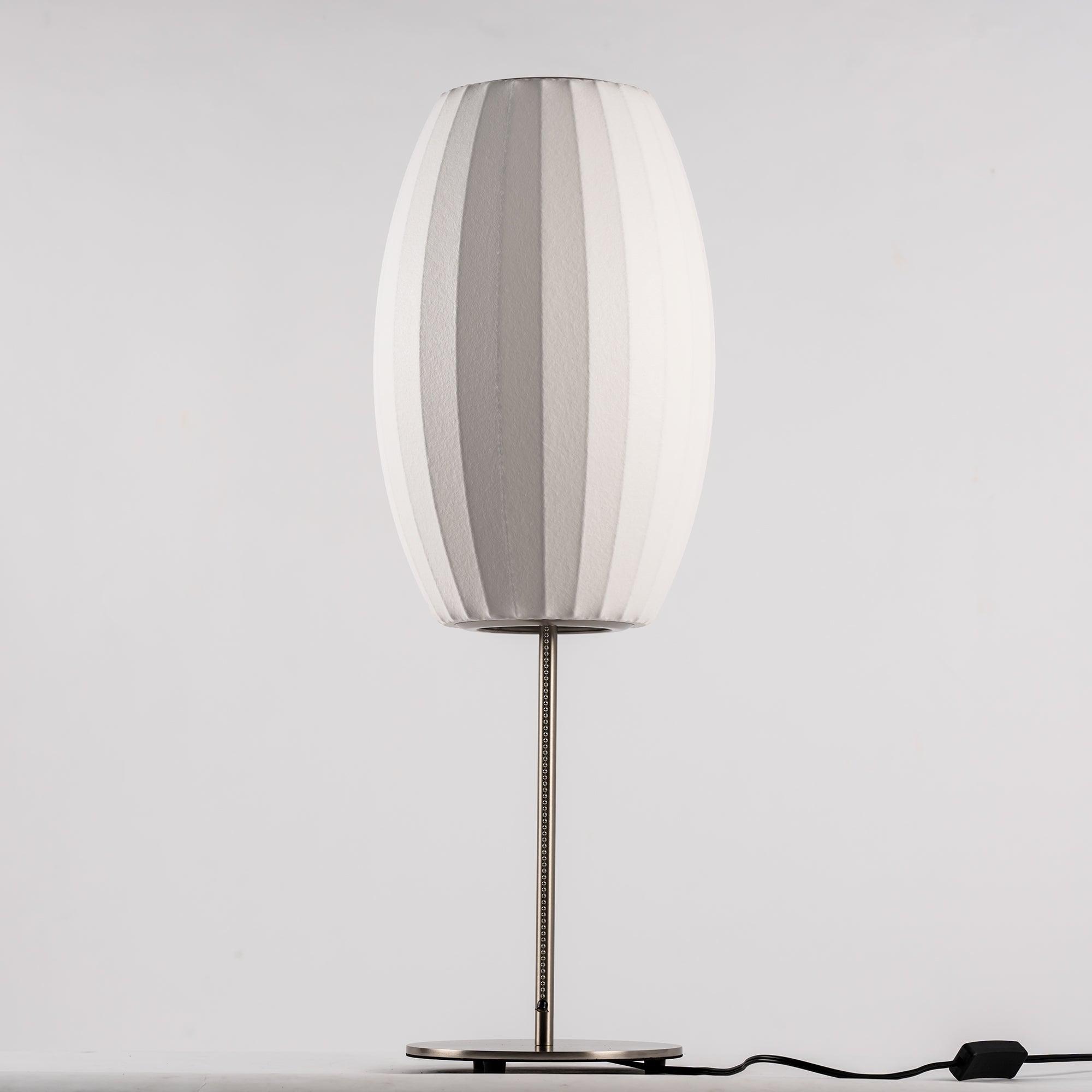 Chrome-stemmed faux silk bubble table lamp glowing in a cosy living room