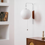 Round white wall sconce mounted on wall with soft ambient light