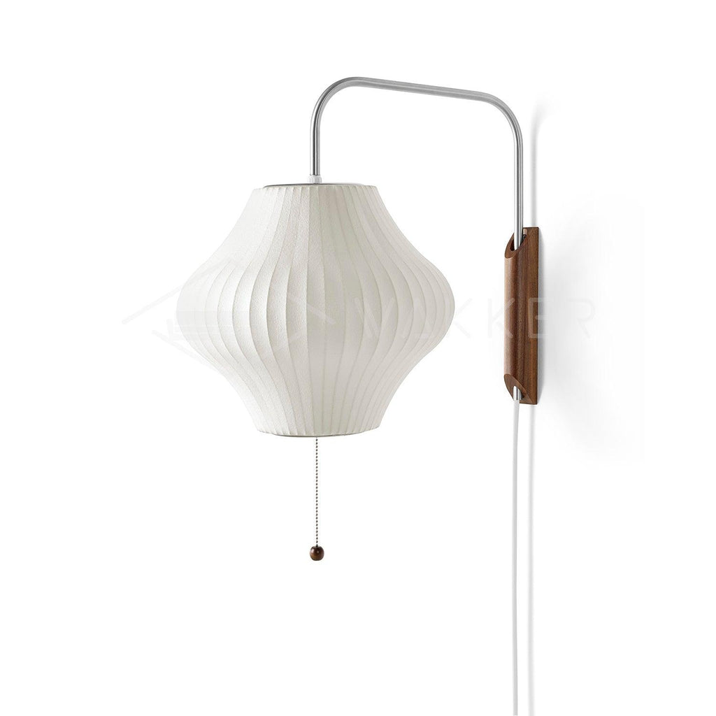 White ball wall sconce glowing softly against a neutral interior wall