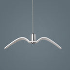 A single white bird-shaped pendant from this Clérachic light hangs against a plain blue-grey backdrop.