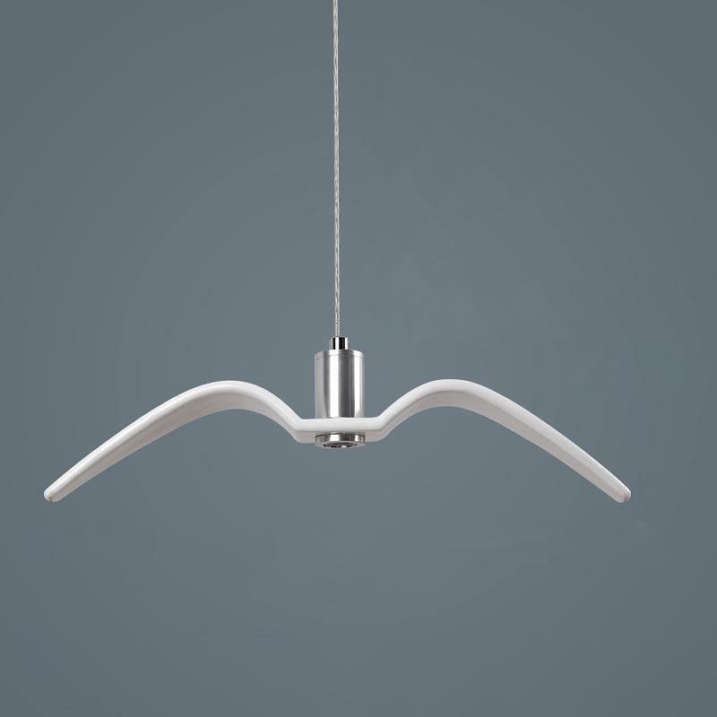 A single white bird-shaped pendant from this Clérachic light hangs against a plain blue-grey backdrop.