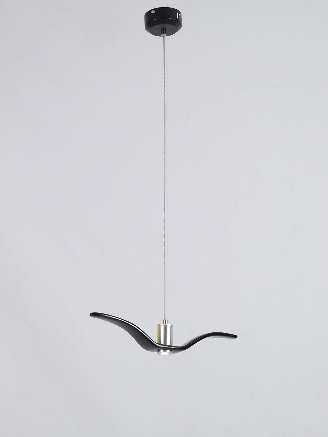 A black bird-shaped pendant from this Clérachic light drops on a long cord from a black ceiling canopy, on a grey backdrop.