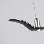 Close view of the nickel neck joint on this black Clérachic bird pendant, its LED lit.