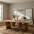 Over a table with cognac leather chairs on steel legs, this Clérachic pendant in brushed nickel clusters its alabaster spheres.
