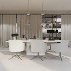 Two cylinder-shaded pendants from this Clérachic collection hang above a curtained office table with white chairs.