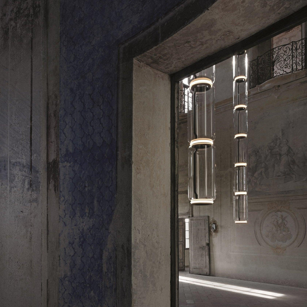 Two cylinder stacks of this Clérachic pendant hang beside a stone archway in a period doorway.