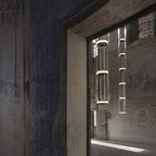 Two cylinder stacks from this Clérachic pendant hang in a weathered stone doorway.