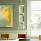 A tripod-legged cone shade on this Clérachic pendant hangs in a green dining nook beside an abstract painting.