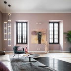 A stack of glass cylinders from this Clérachic pendant hangs beside tall windows in a mauve room with framed art.