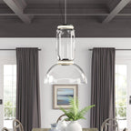 This Clérachic pendant's dome-shaped shade hangs between grey curtains above a table with a potted fern.