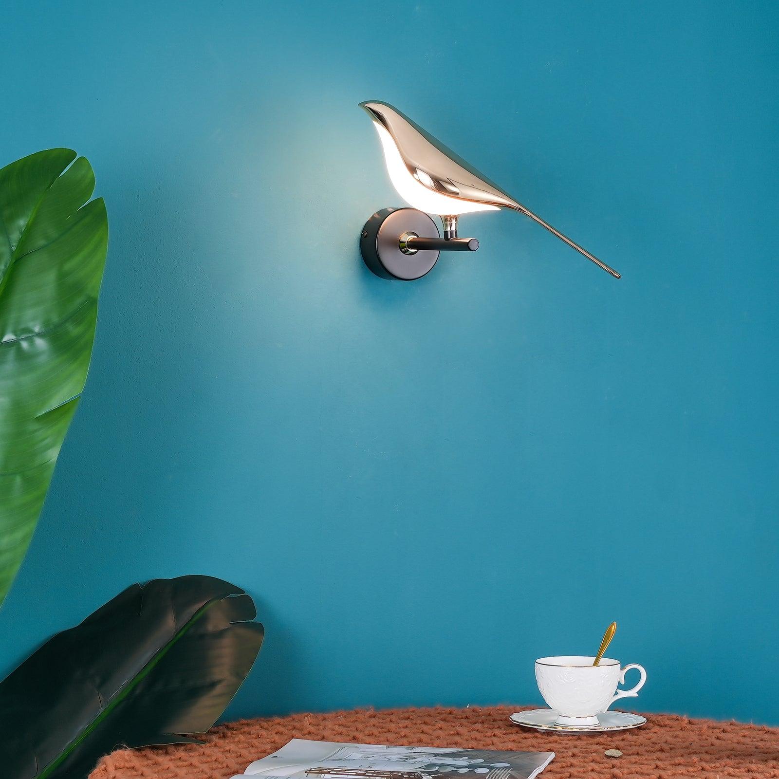 Bird-shaped Nomi wall lamp glowing in a warm room setting