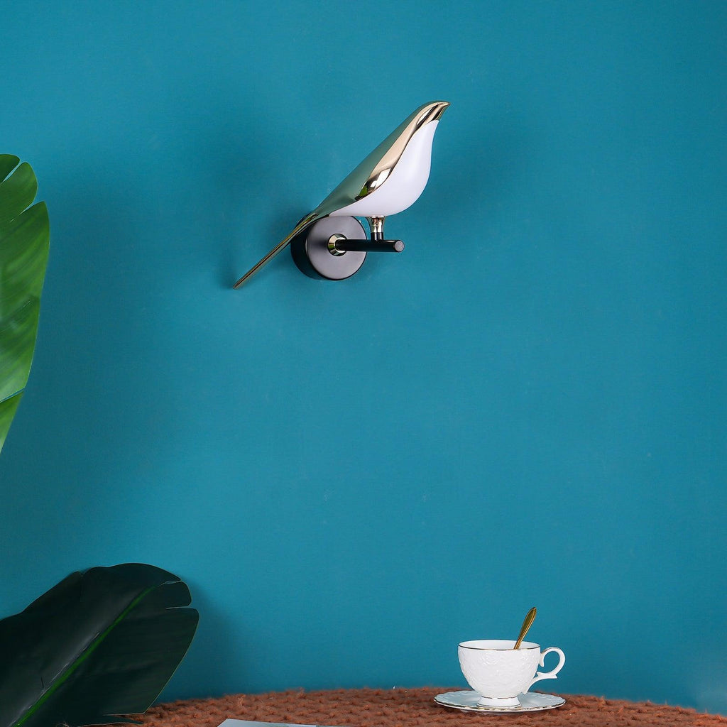 Black and rose gold Nomi wall lamp adding a playful accent to a wall