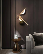 Nomi wall lamp single head glowing warmly against a neutral wall