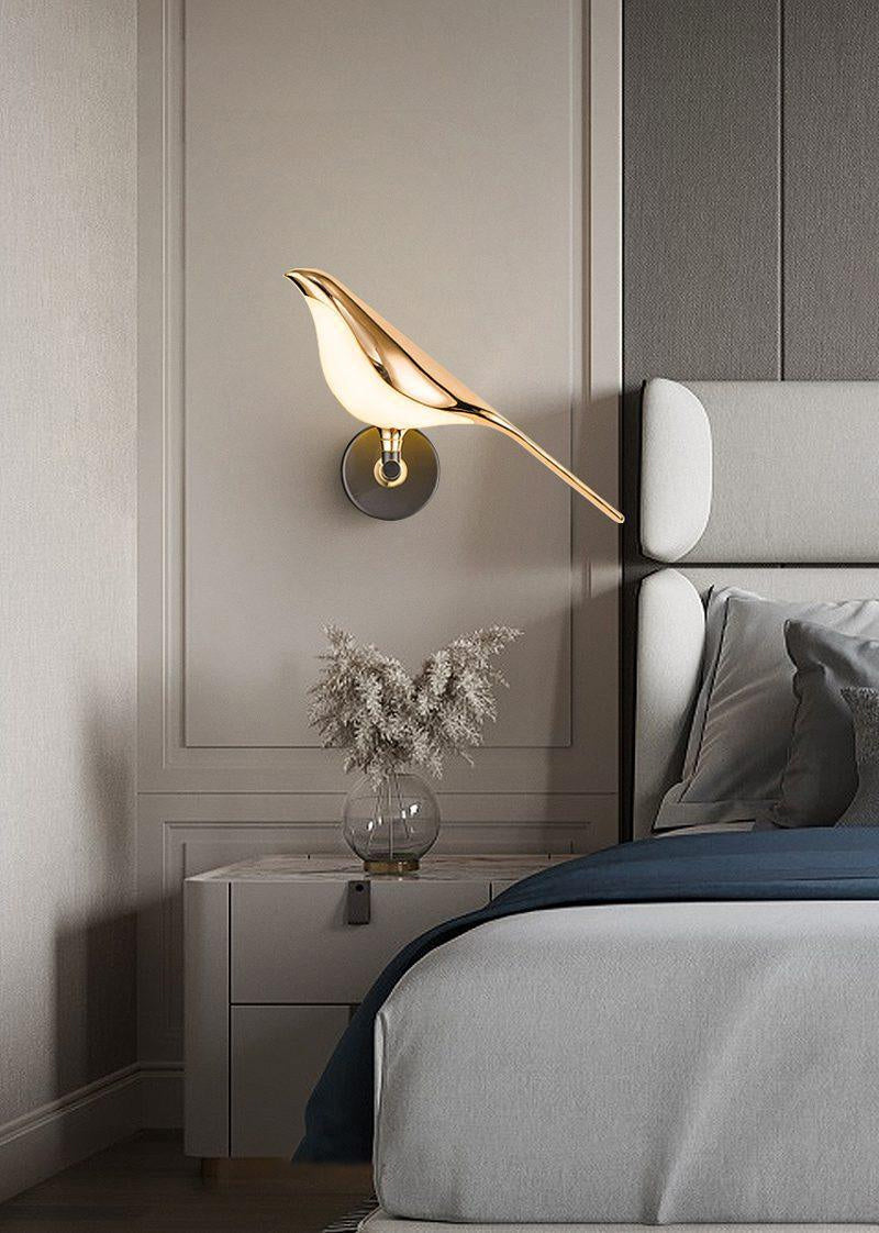 Close-up of the rose gold bird detail on the Nomi wall lamp
