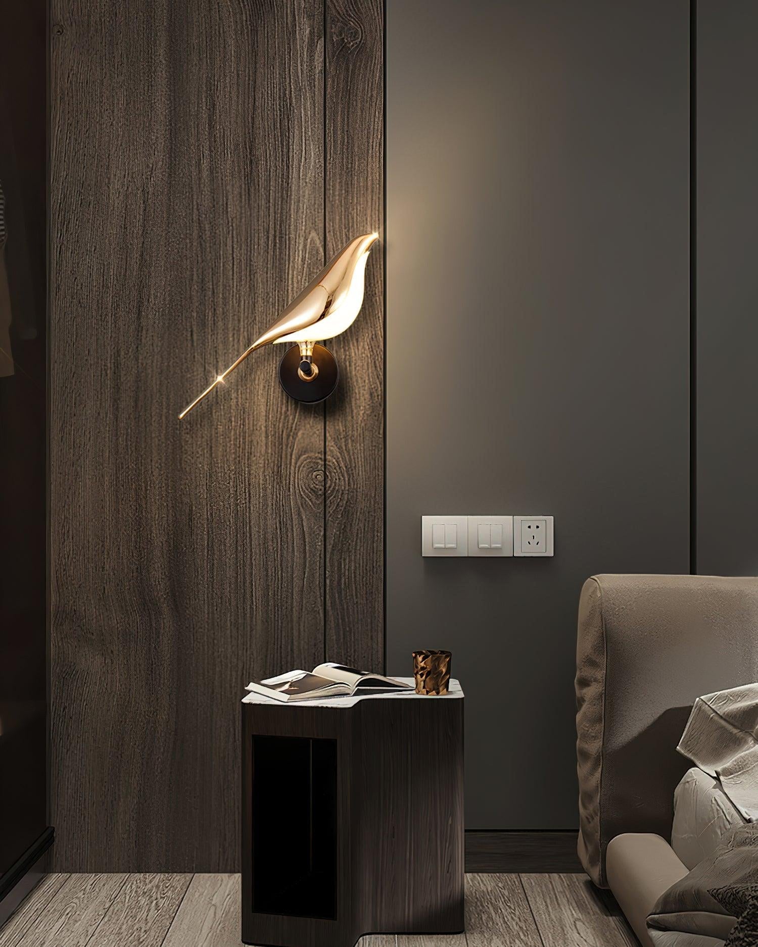 Nomi wall lamp shown lit beside a bed for soft ambient light