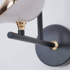 Bird-shaped Nomi wall lamp styled in a modern bedroom
