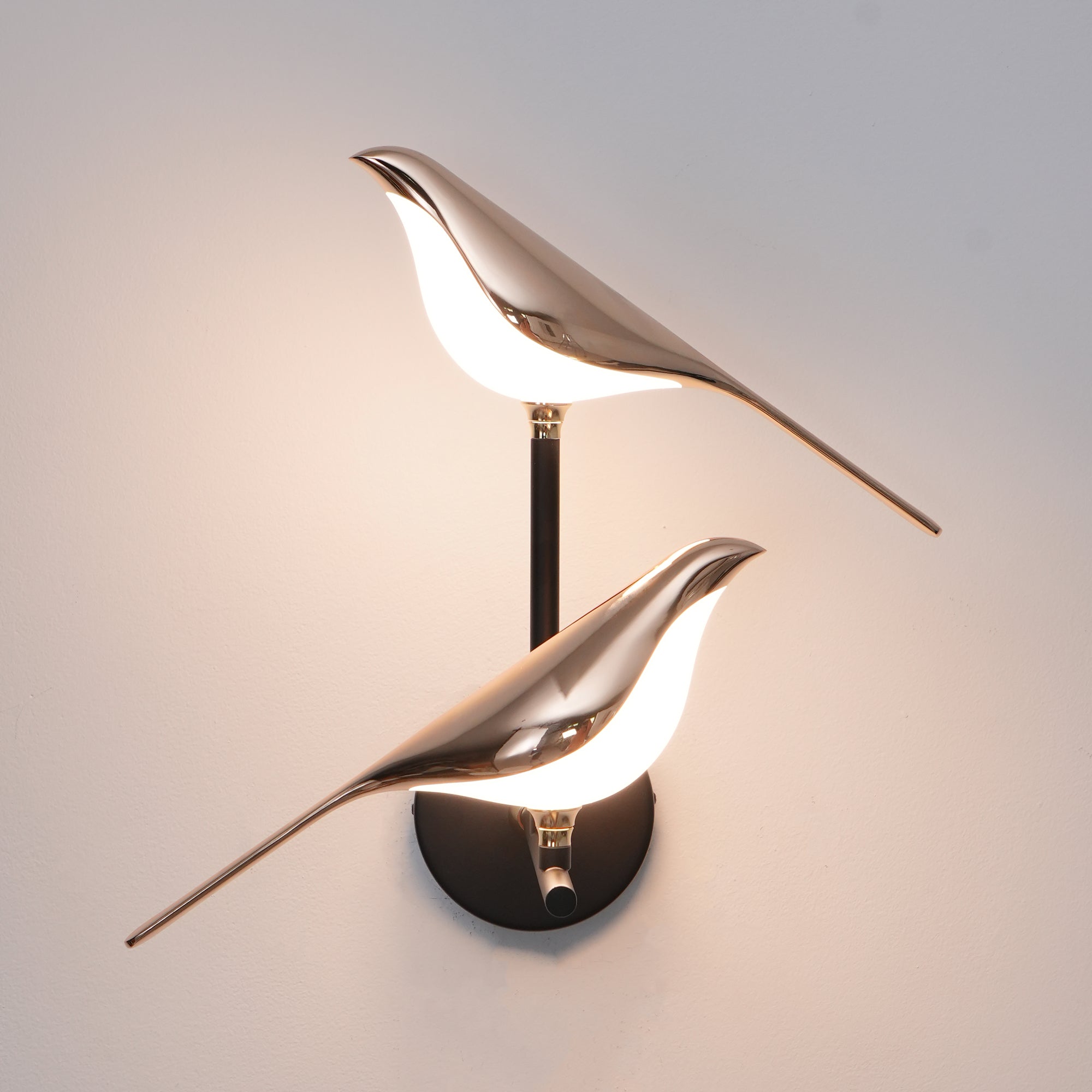 Bird-shaped Nomi wall lamp adding warm character to a room