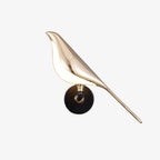 Nomi wall lamp with the decorative bird perched on the lamp rod