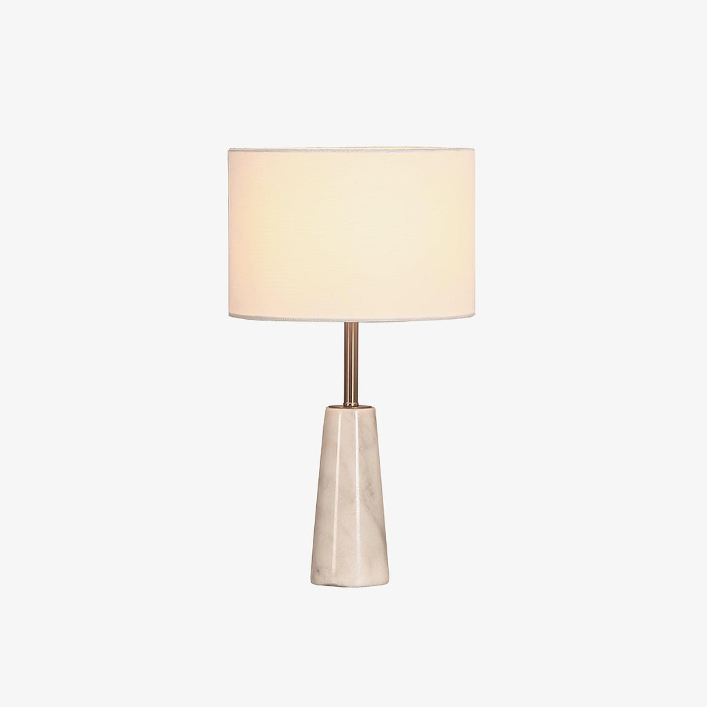 Clérachic table lamp cropped closer with its shade glowing warm against a plain white backdrop.