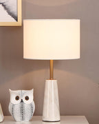 Clérachic lamp lit beside a patterned ceramic owl figurine on a grey-walled nightstand scene.