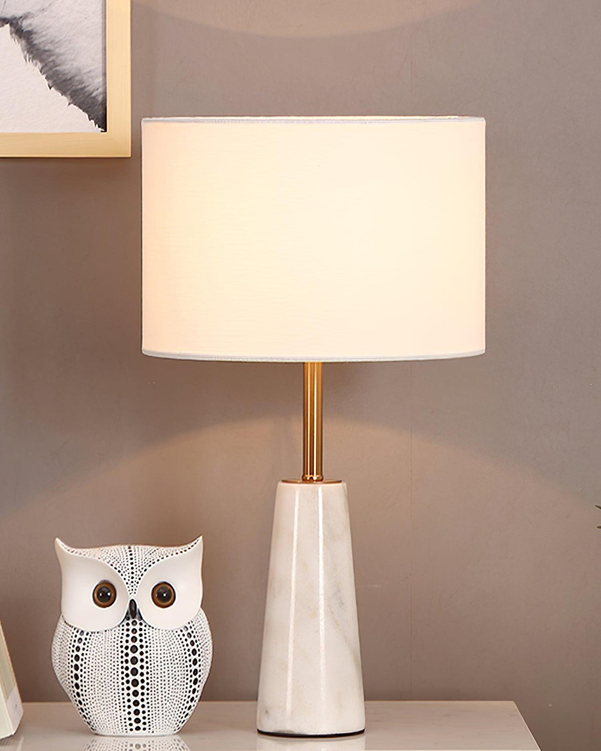 Clérachic lamp lit beside a patterned ceramic owl figurine on a grey-walled nightstand scene.