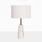 Clérachic table lamp shown full height on a reflective white surface, its faceted base doubled below it.