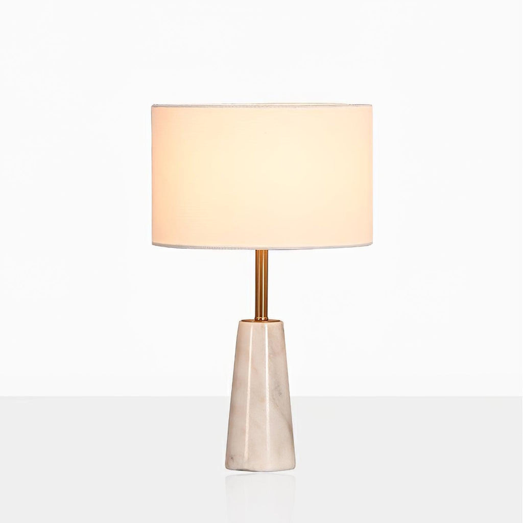 Clérachic lamp with its drum shade glowing warm, cropped closer against a soft grey studio gradient.