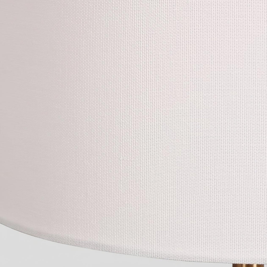 Macro close-up of the woven white fabric texture on this Clérachic table lamp's drum shade.