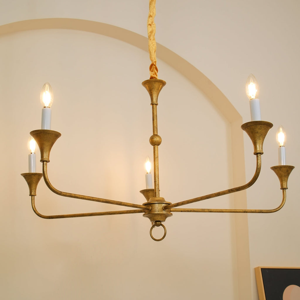 Candle chandelier shown lit above a seating area