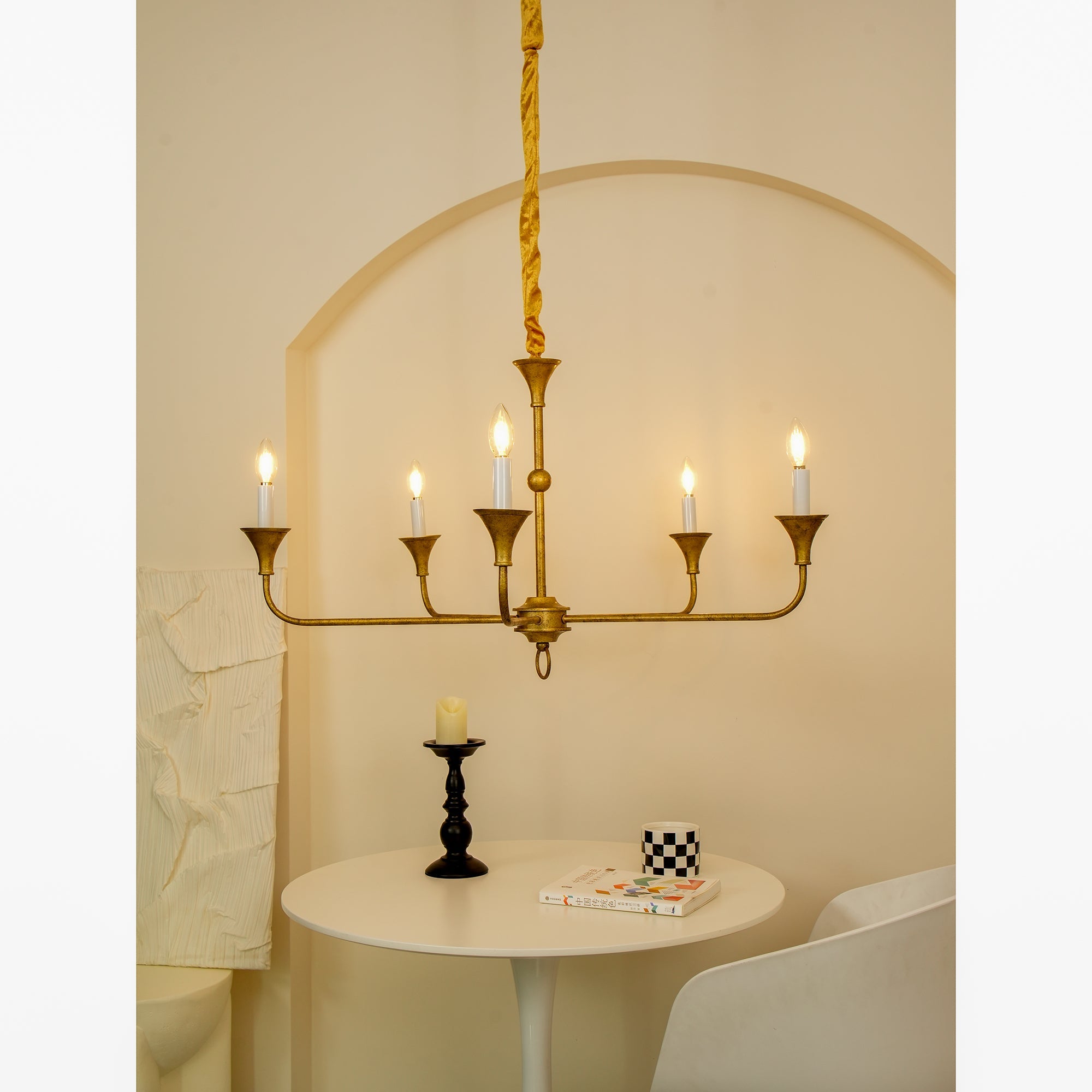 Candle chandelier viewed against a neutral wall to show its outline