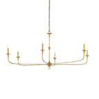 Candle chandelier shown lit above a living area