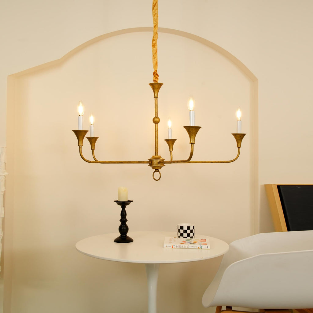 Candle chandelier in a styled room with warm ambient lighting