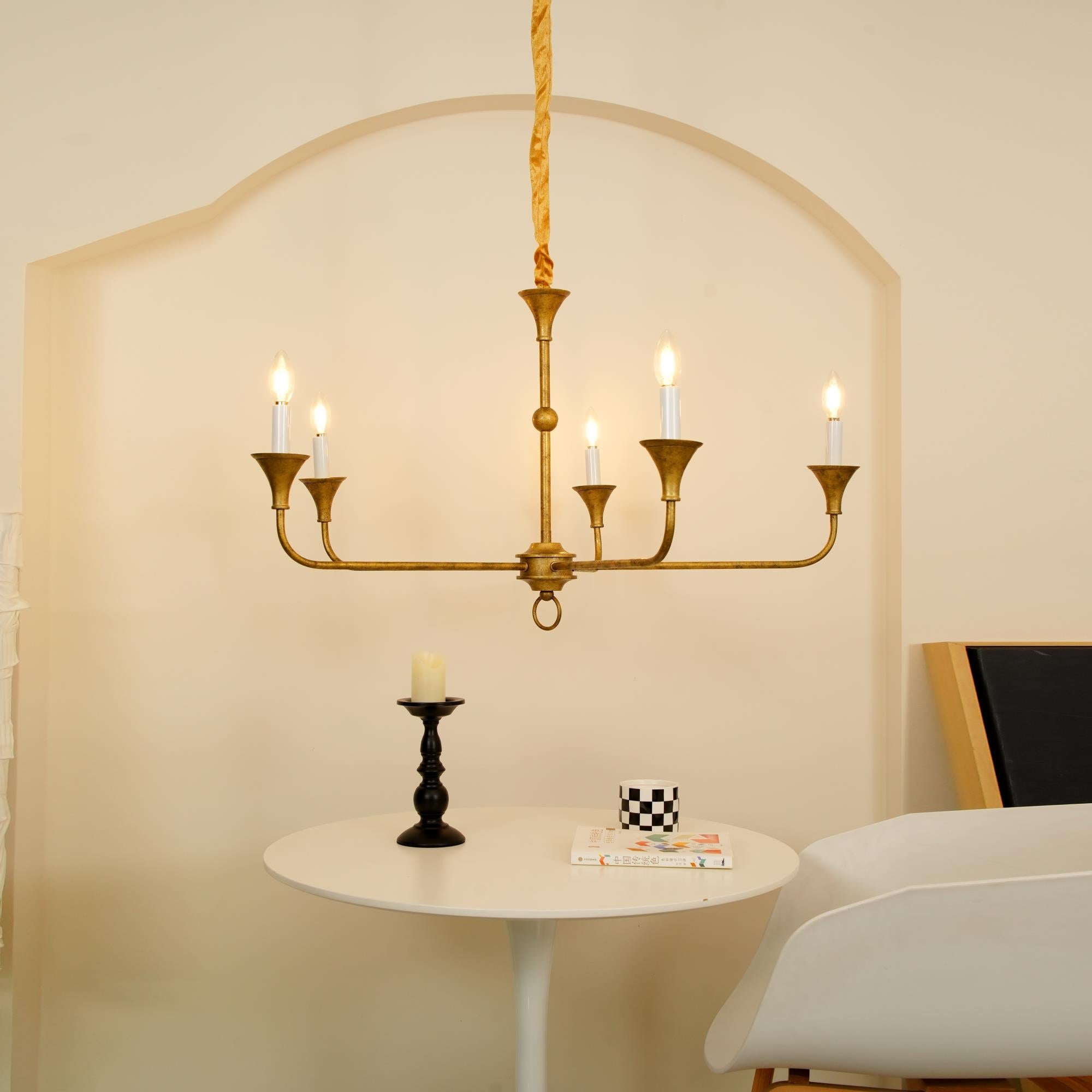 Candle chandelier in a styled room with warm ambient lighting