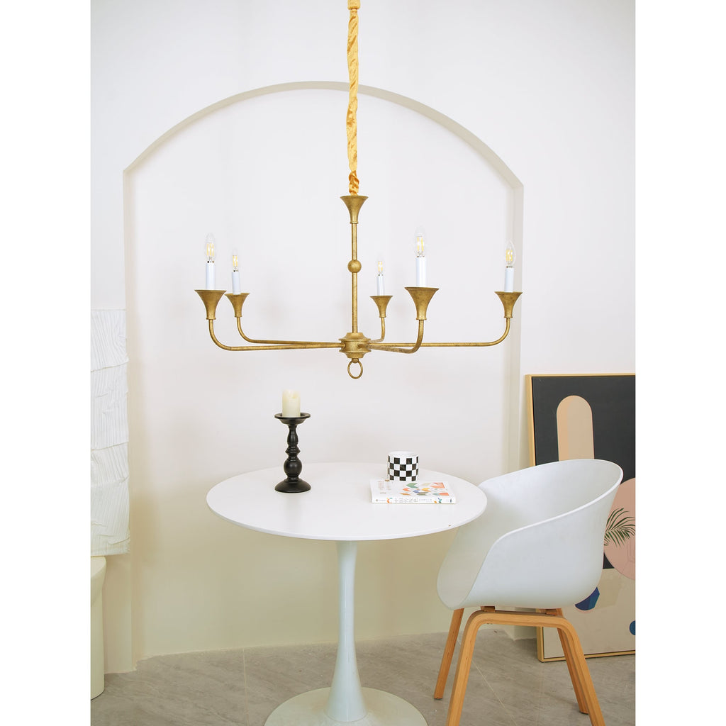 Candle chandelier suspended in an airy interior space